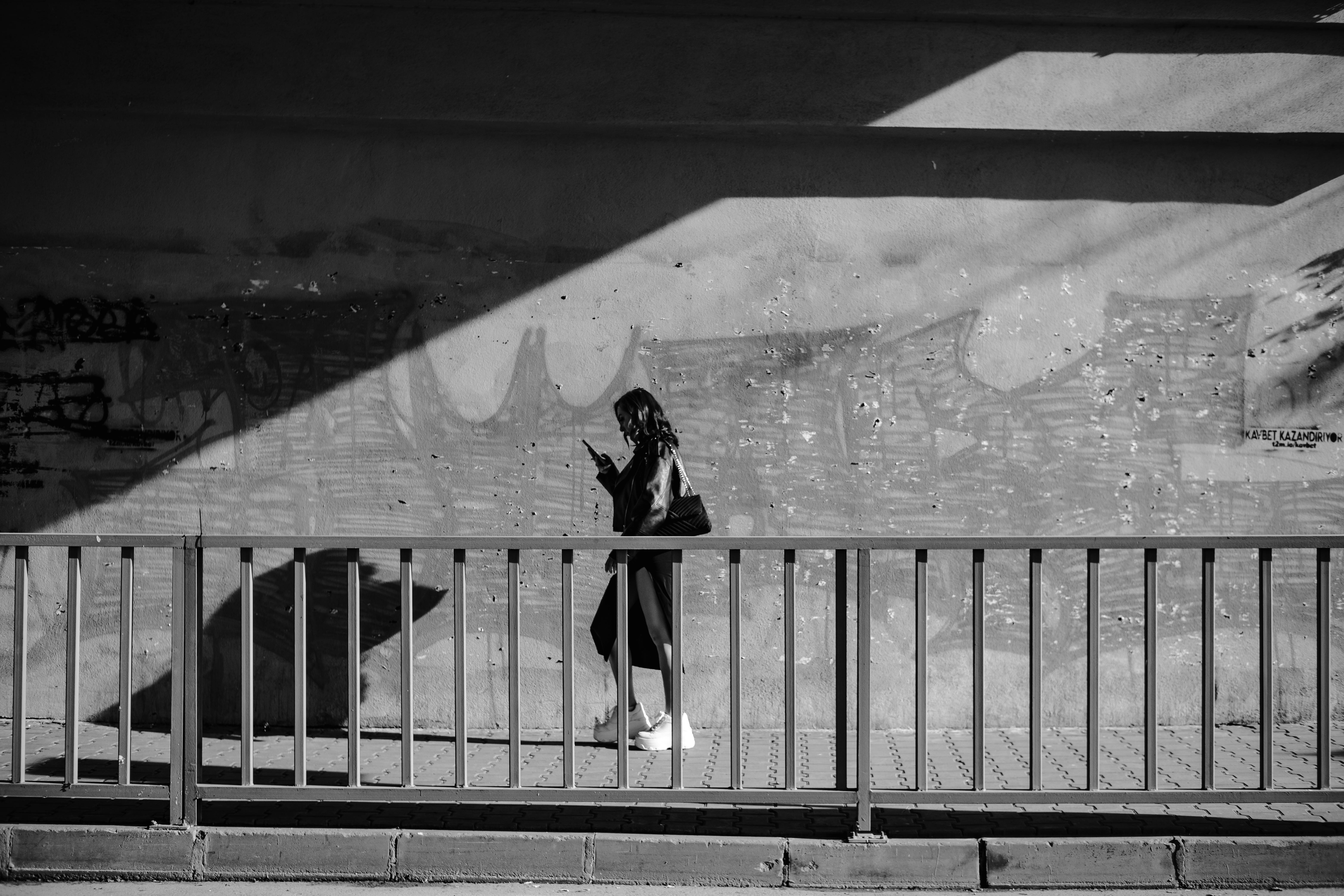 Woman walking in an alley, black and white